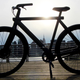 A photo of a VanMoof electric bike with the Empire State Building in the background.